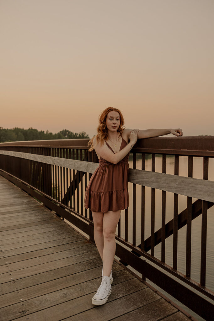 unique poses on bridge in iowa for senior photoshoot