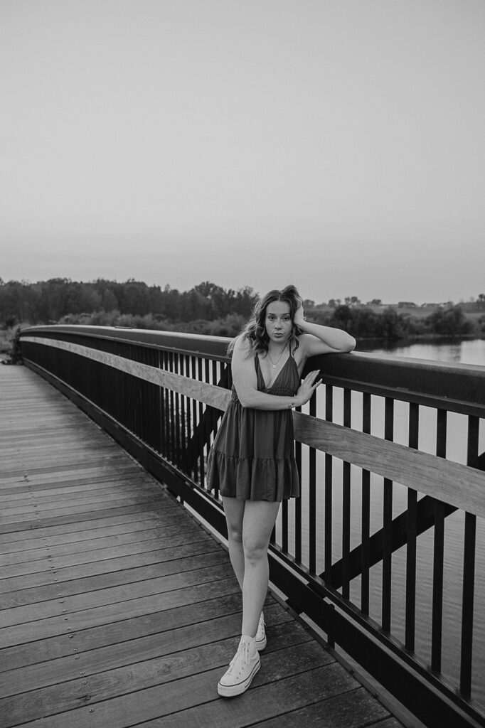 unique poses on bridge in iowa for senior photoshoot