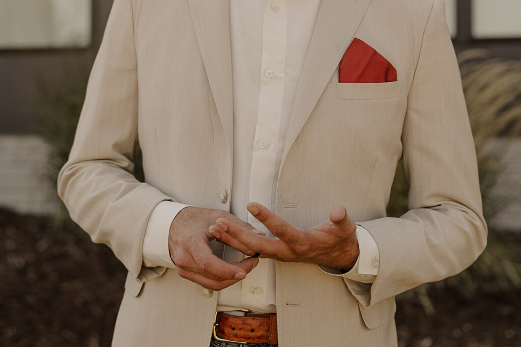 groom getting ready photos before outdoor wedding ceremony