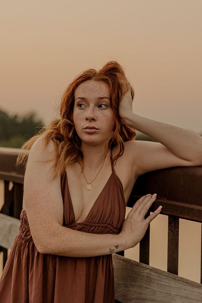 unique poses on bridge in iowa for senior photoshoot