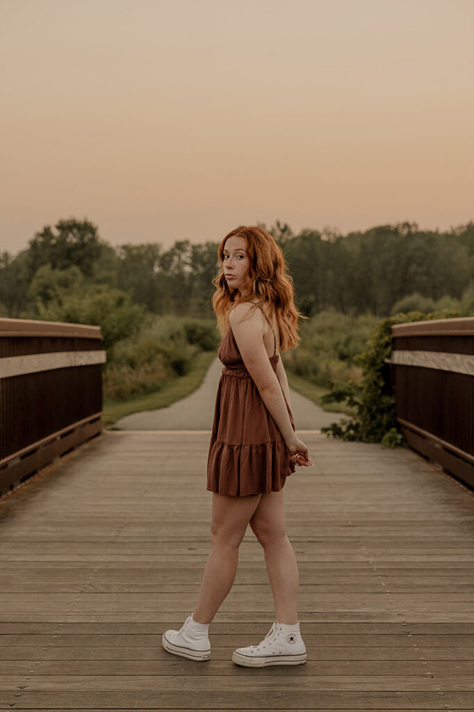 unique poses on bridge in iowa for senior photoshoot