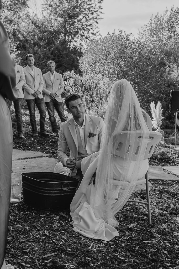 bride and groom washing each others feet christ centered wedding ceremony