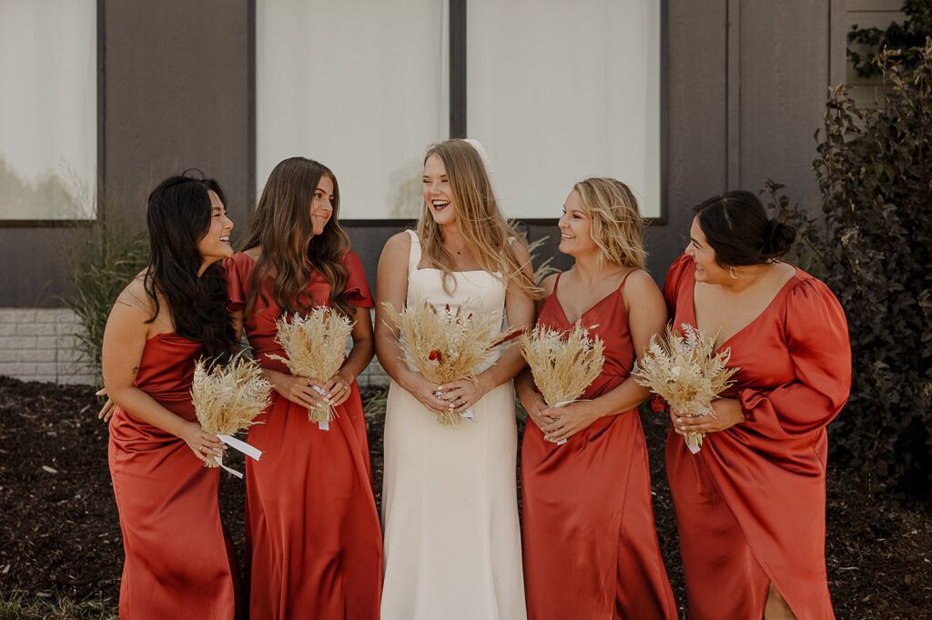 burnt orange bridesmaid dresses and pampas bouquets