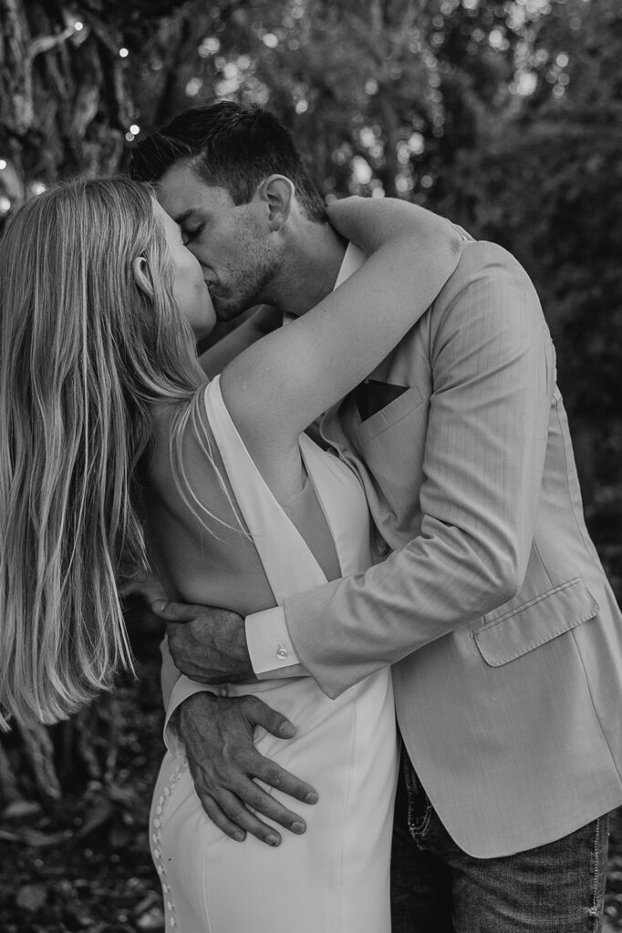 bride and groom hugging and kissing during wedding reception iowa wedding photographer