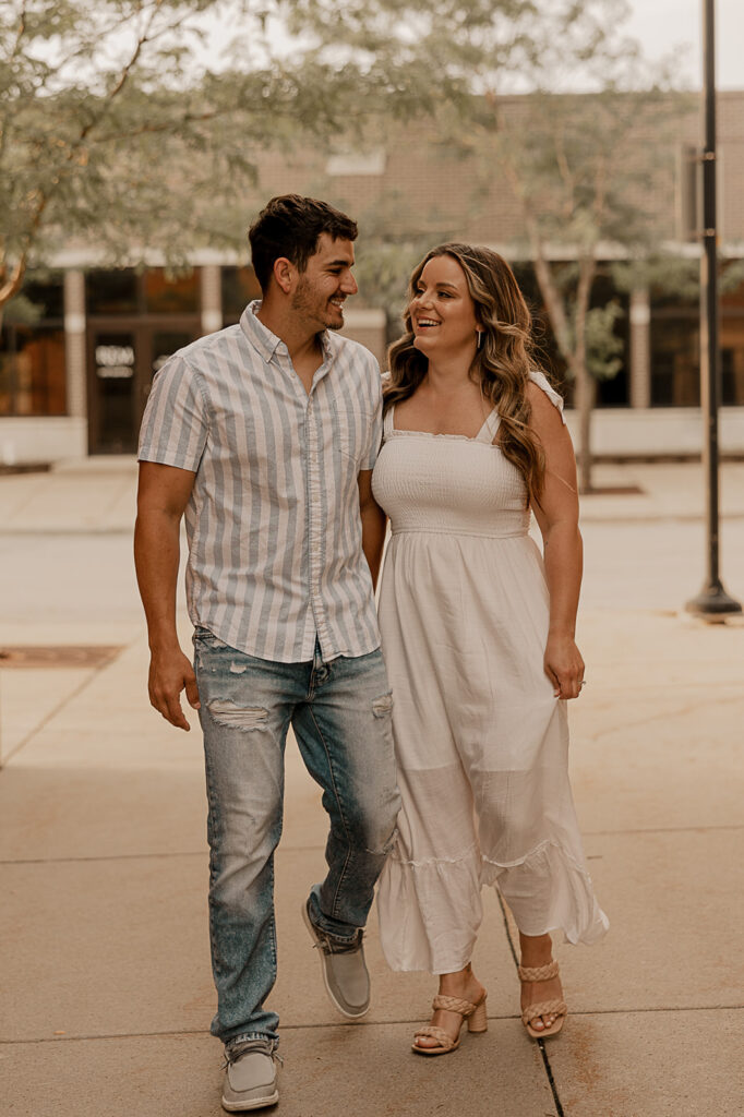 couple holding hands and walking in ames iowa