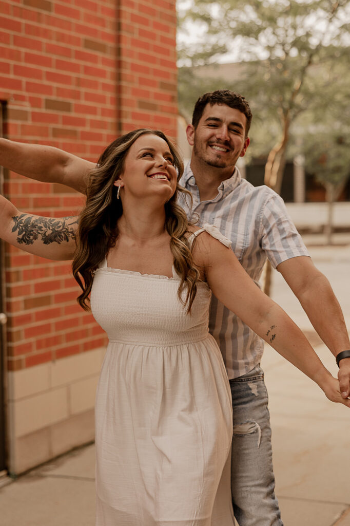 playful airplane pose for couples