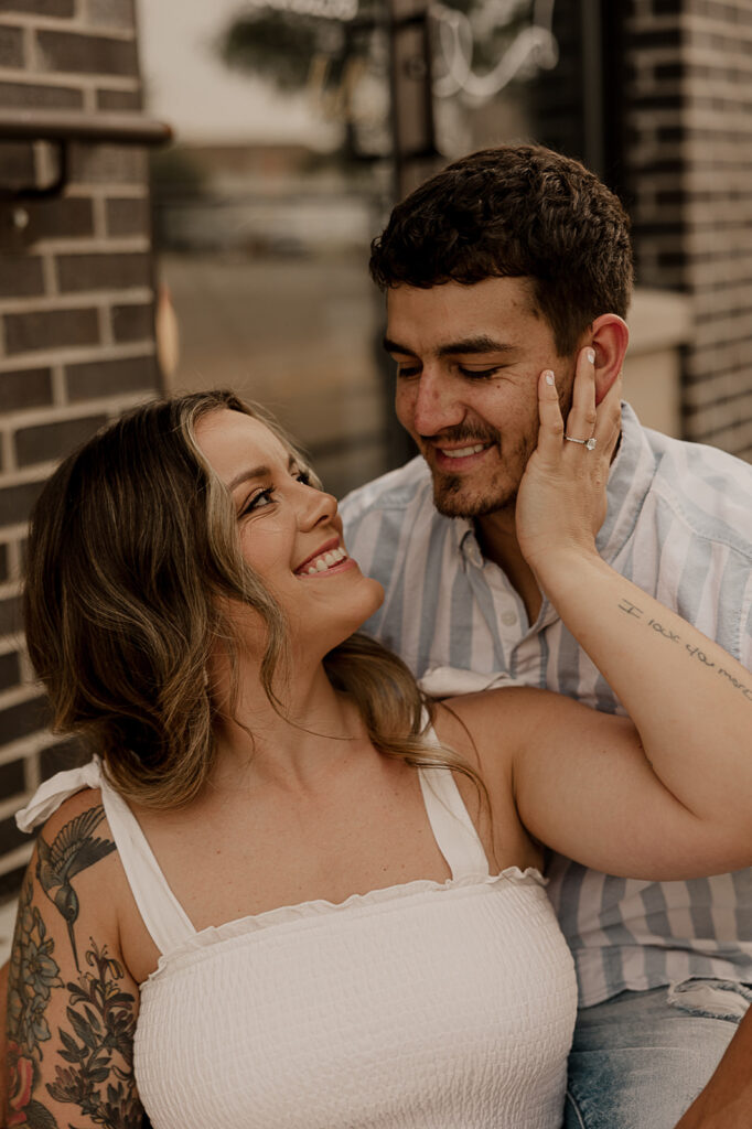 couple smiling candid poses for engagement photos fun