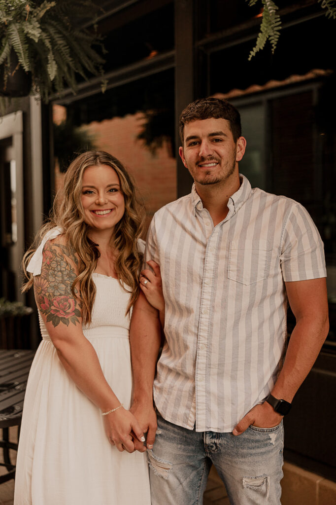 couple smiling and holding hands engagement photos fun