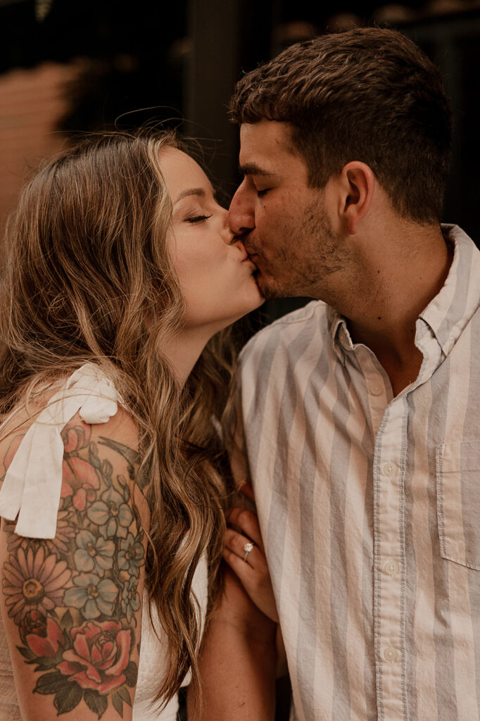 couple kissing engagement photos outfits