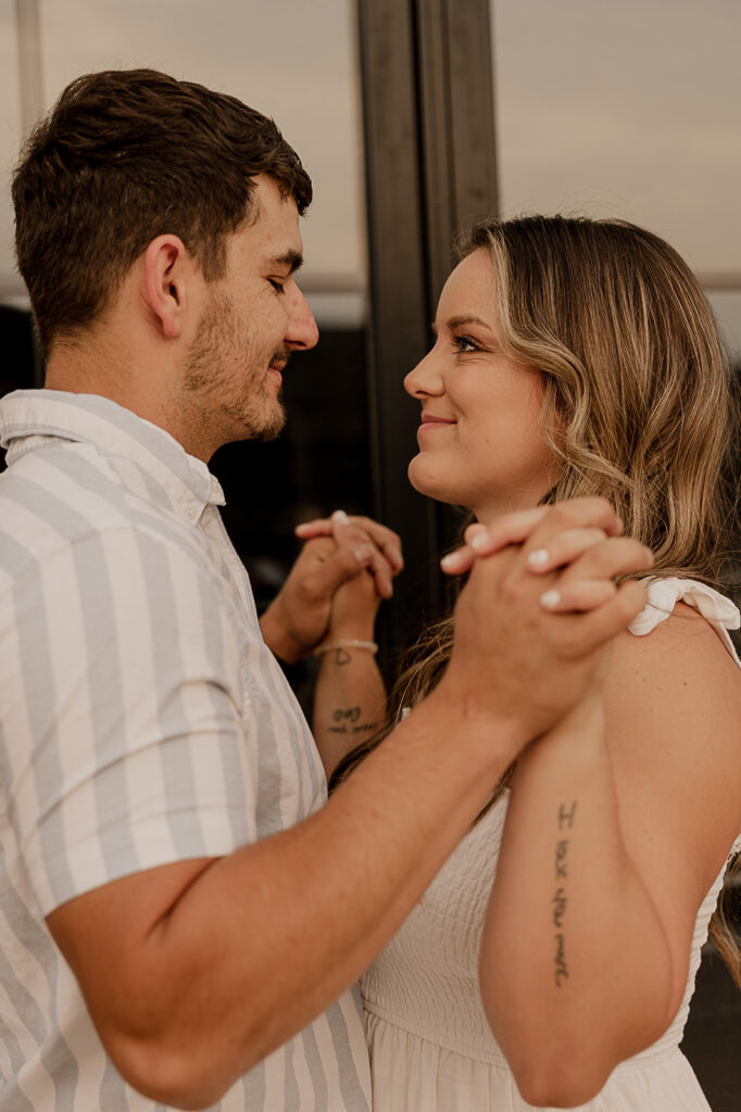 couple holding hands and smiling at each other