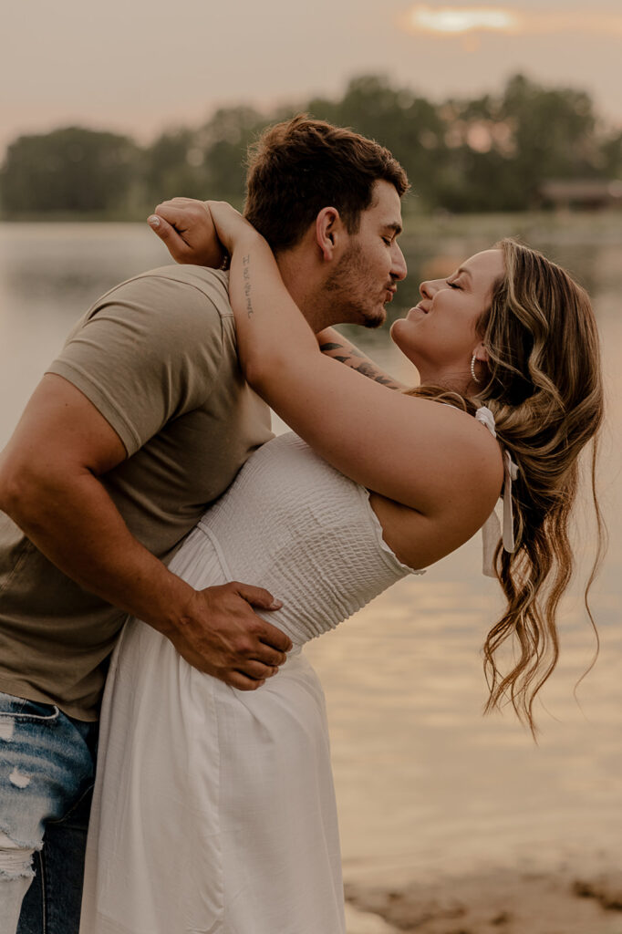 couple candid kissing and hugging engagement photos fun