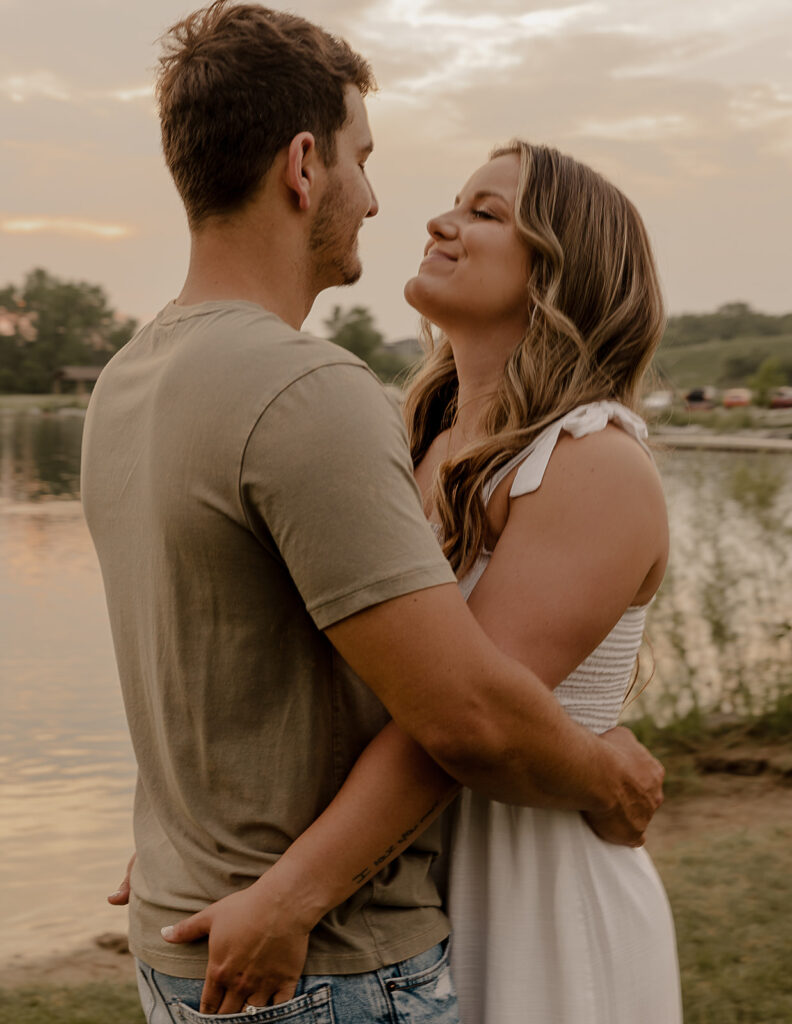 couple candid poses smiling playful engagement session