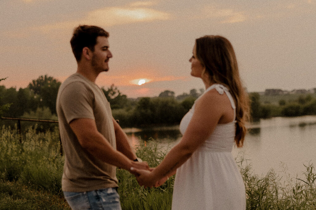 grainy couples photos during golden hour holding hands