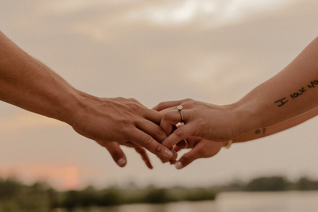 engagement ring photos detail shots hands holding with sunset in background