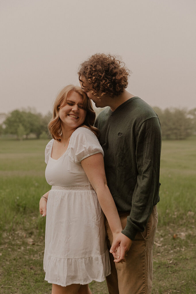 engagement in iowa couple smiling candid poses