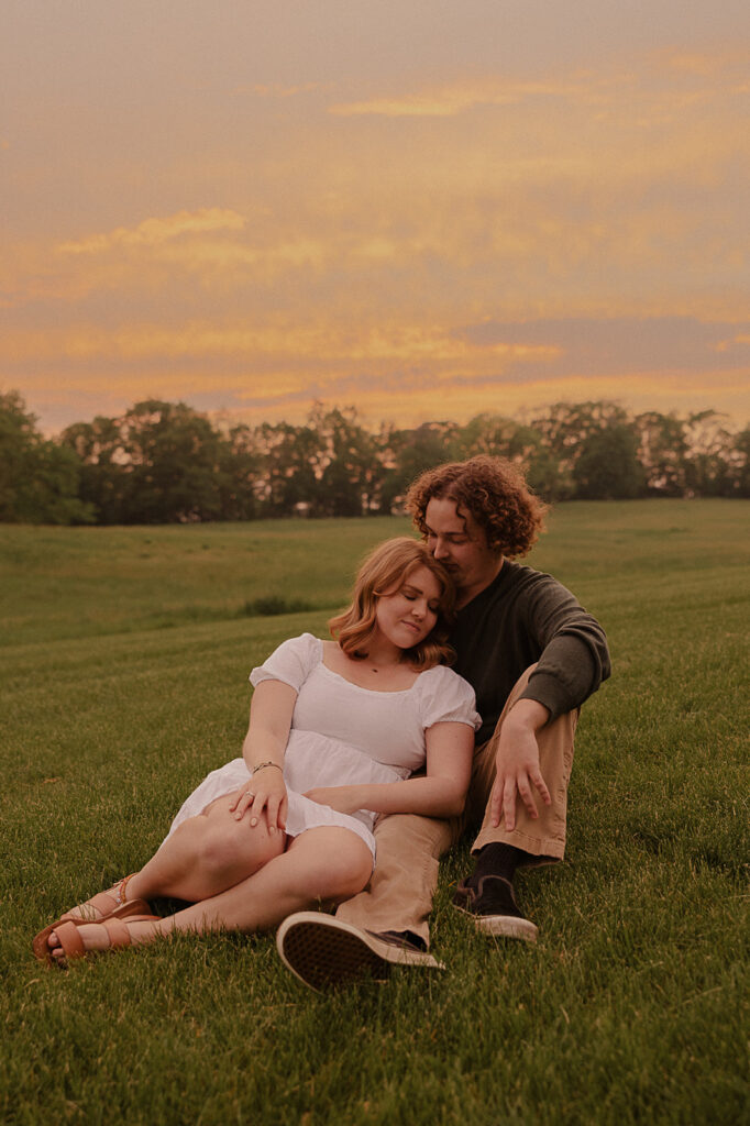 sunset engagement session romantic pose in a field