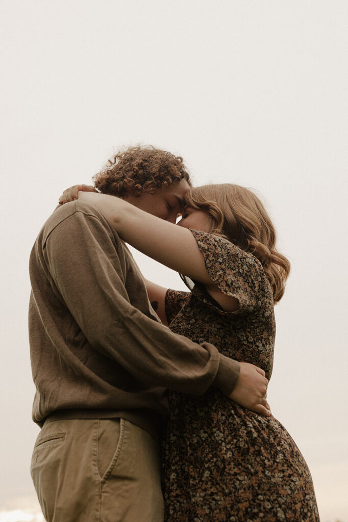 couple hugging and touching foreheads