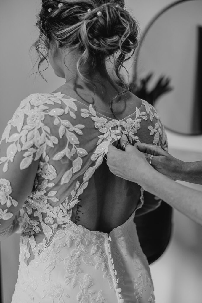 bride putting on dress documentary style wedding photography