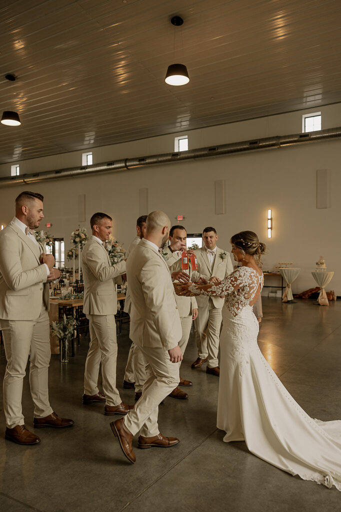 first look with groomsmen iowa wedding photographer