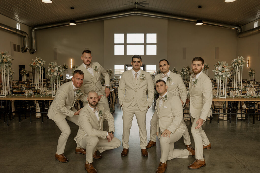 candid groomsmen poses eagles ledge wedding