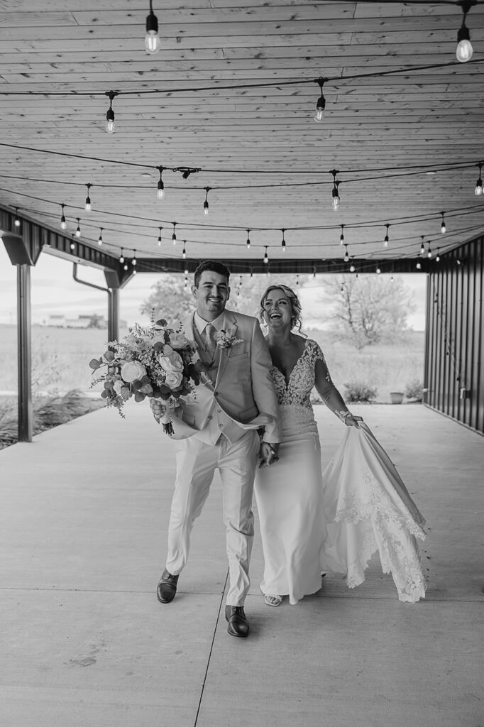 bride and groom dancing under cafe lights