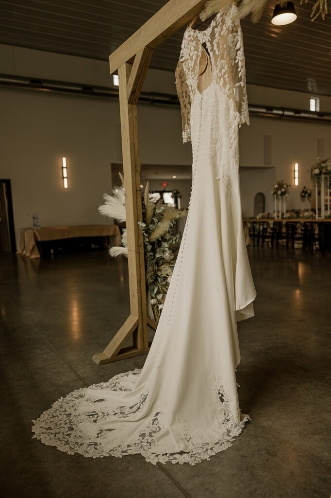 wedding getting ready photos dress hanging on altar