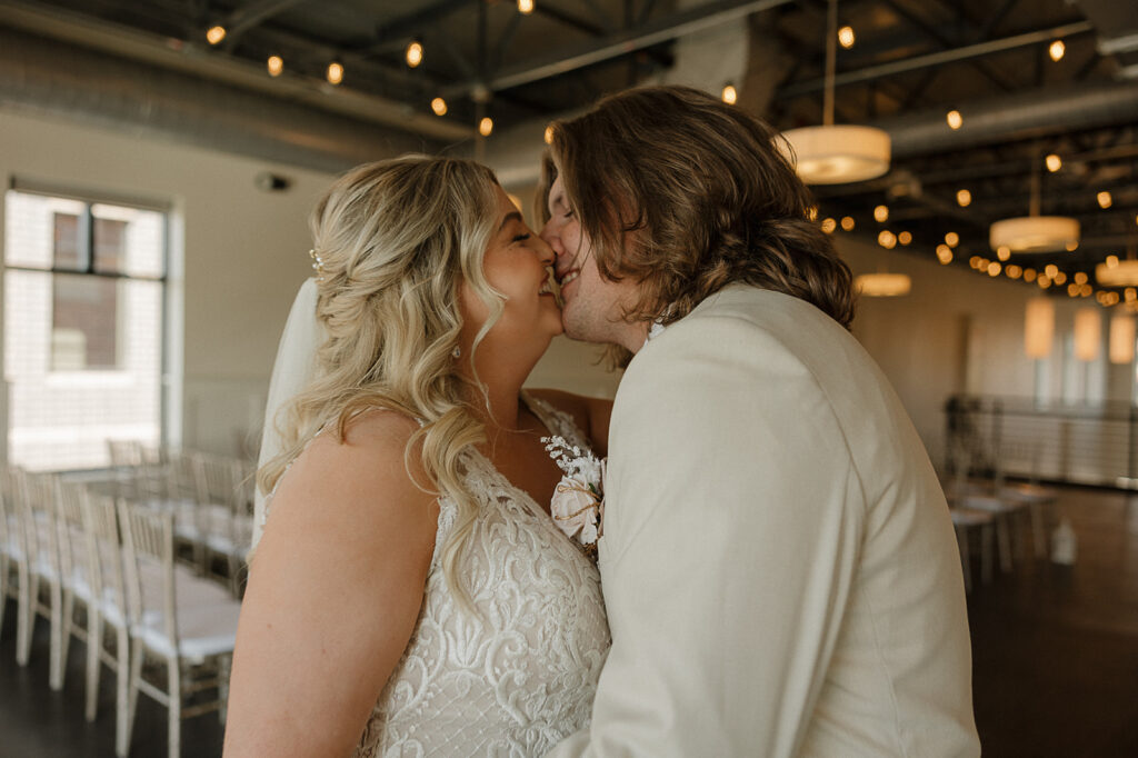 bride and groom kissing pose indoor portraits