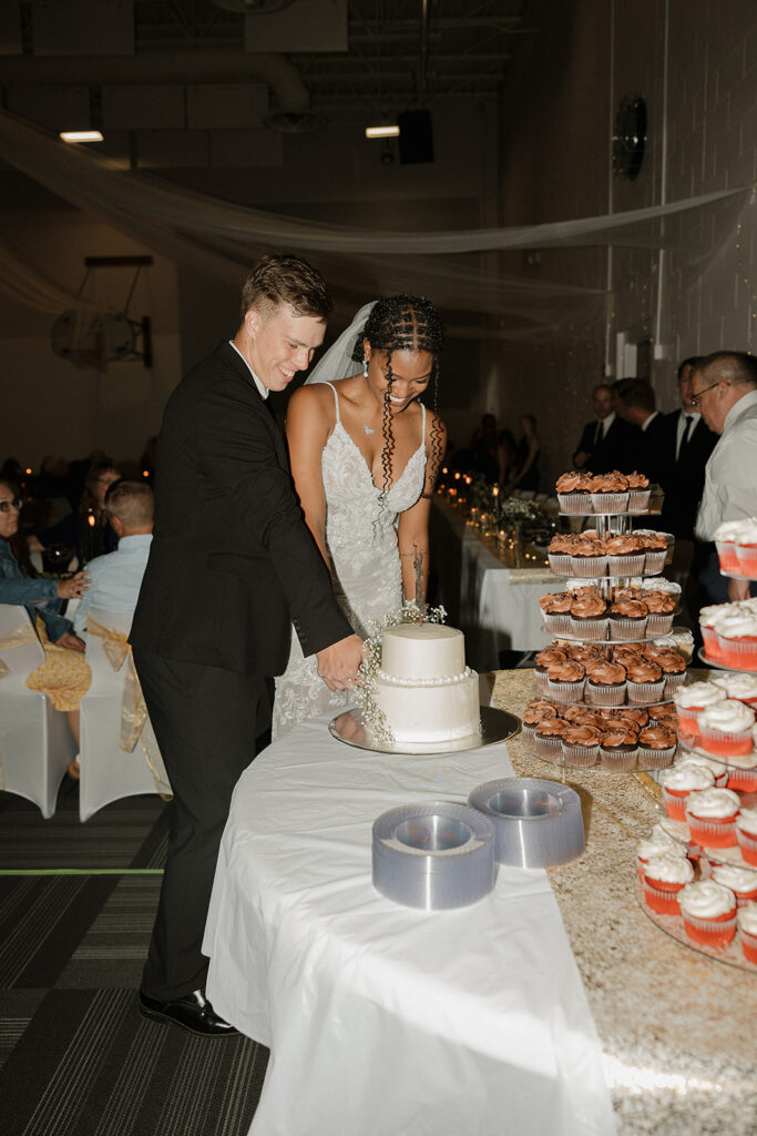 flash wedding reception photos bride and groom cutting cake