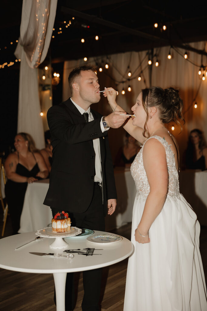 flash reception photos bride and groom cutting the cake