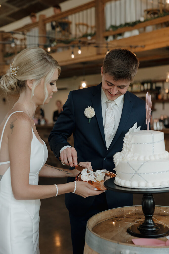 bride and groom cutting the cake