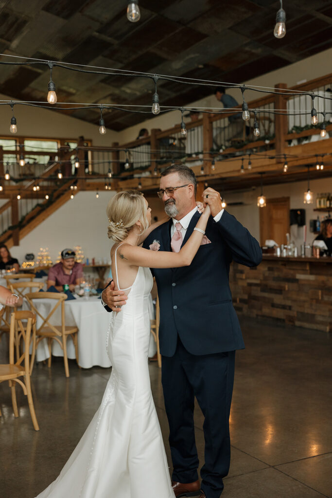 bride and groom dance with dad