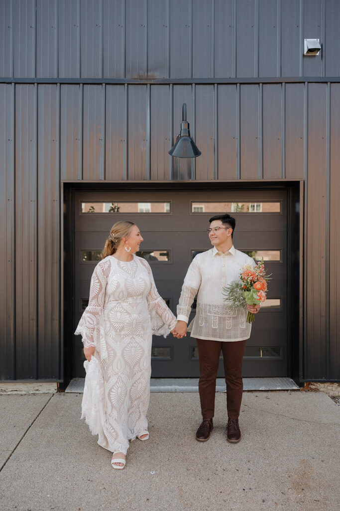 bride and groom portraits in front of garage