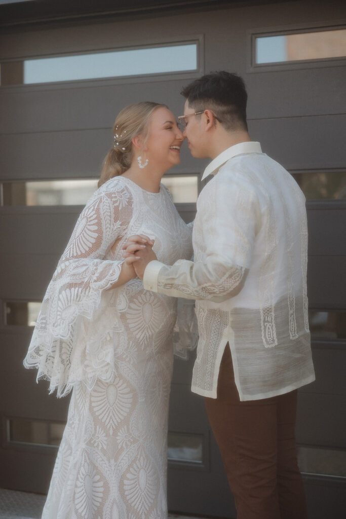 bride and groom portraits in front of garage