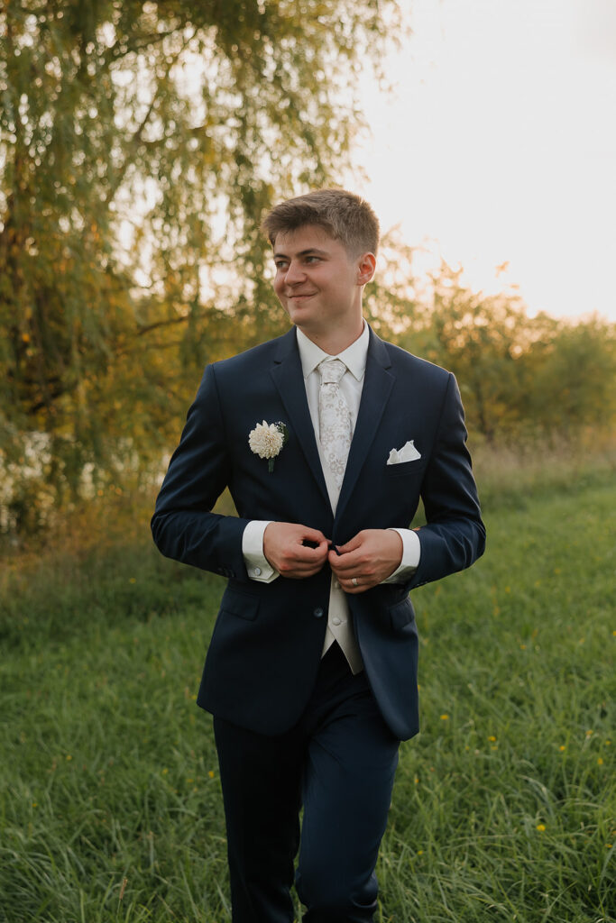 couple photos in front of willow tree during sunset after wedding ceremony