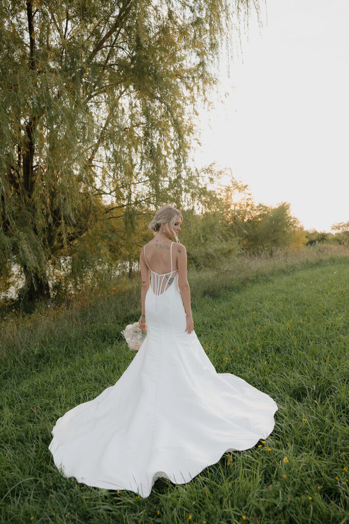 couple photos in front of willow tree during sunset after wedding ceremony