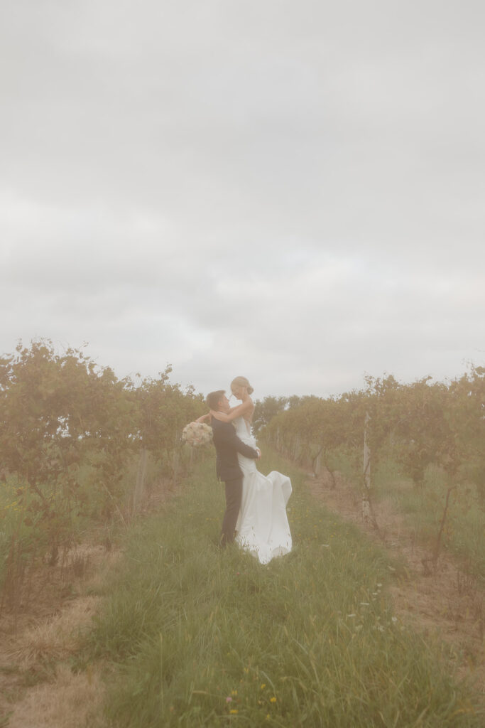 sunset wedding pictures with bride and groom in a vineyard