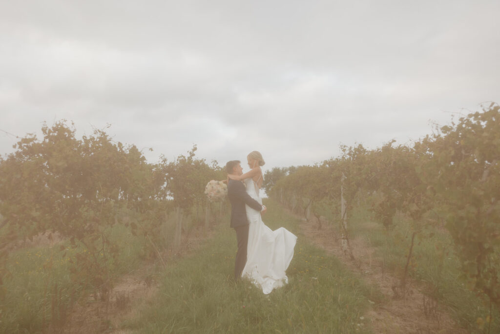 sunset wedding pictures with bride and groom in a vineyard