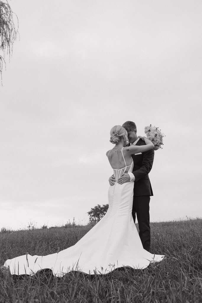 couple photos in front of willow tree during sunset after wedding ceremony