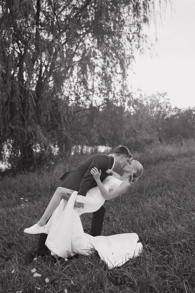 couple photos in front of willow tree during sunset after wedding ceremony