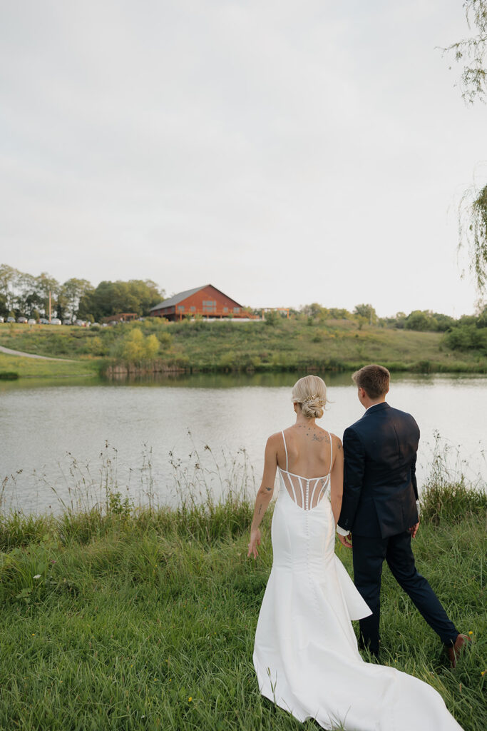 couple photos in front of willow tree during sunset after wedding ceremony