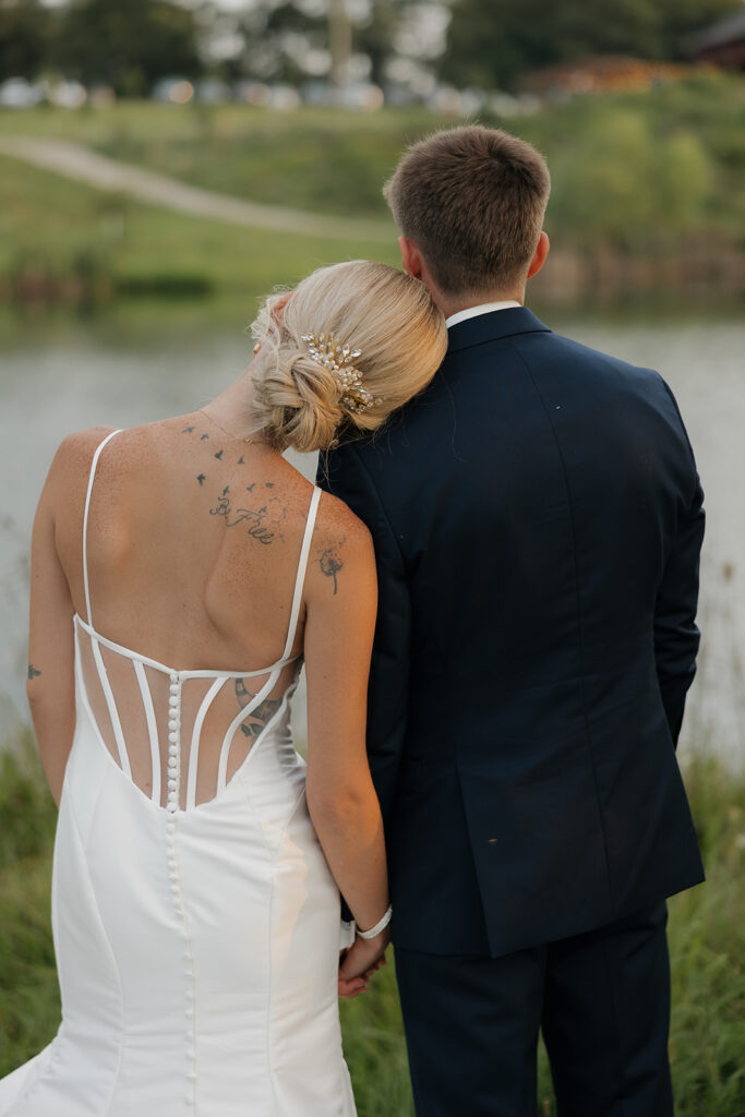 couple photos in front of willow tree during sunset after wedding ceremony