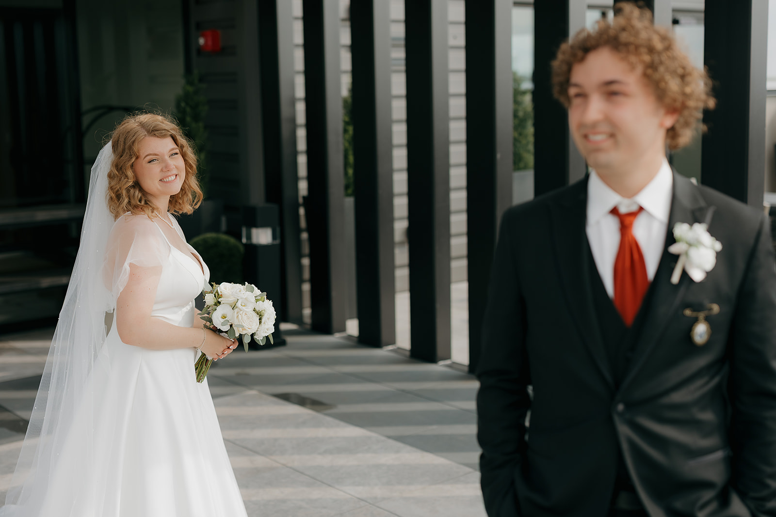Bride smiling at the groom during their first look outdoors — a natural moment that exemplifies documentary wedding photography