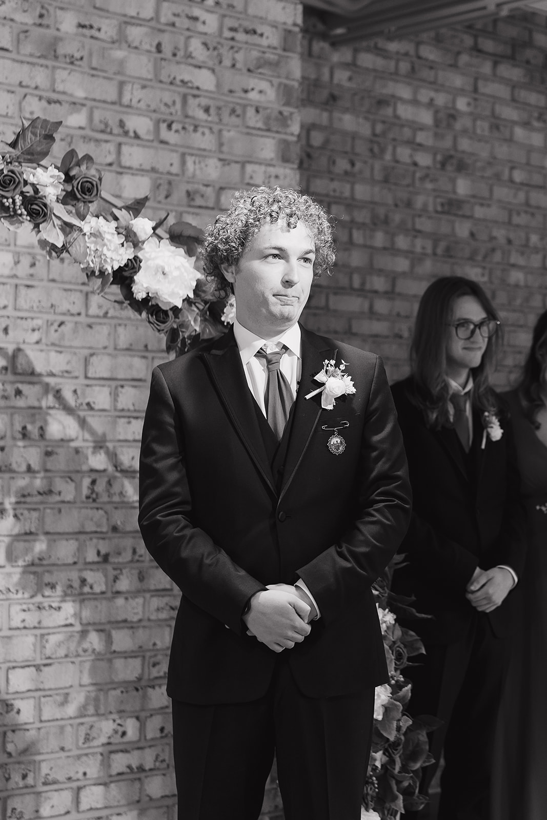 Groom standing at the altar, emotional as he waits for the bride to walk in