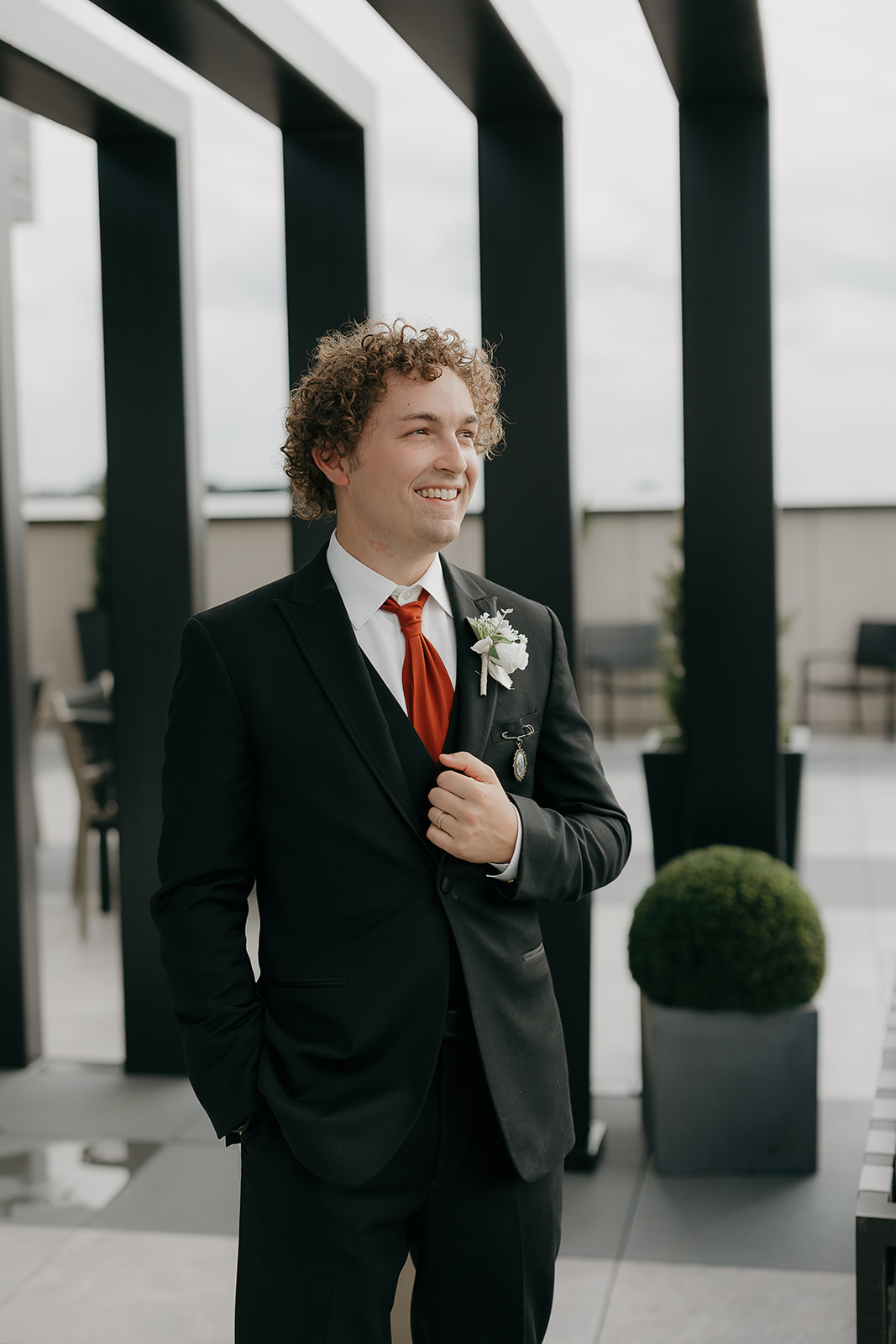 The groom smiling away from the photographer gor some groom style protraits. The perfect example of docmentary wedding photography