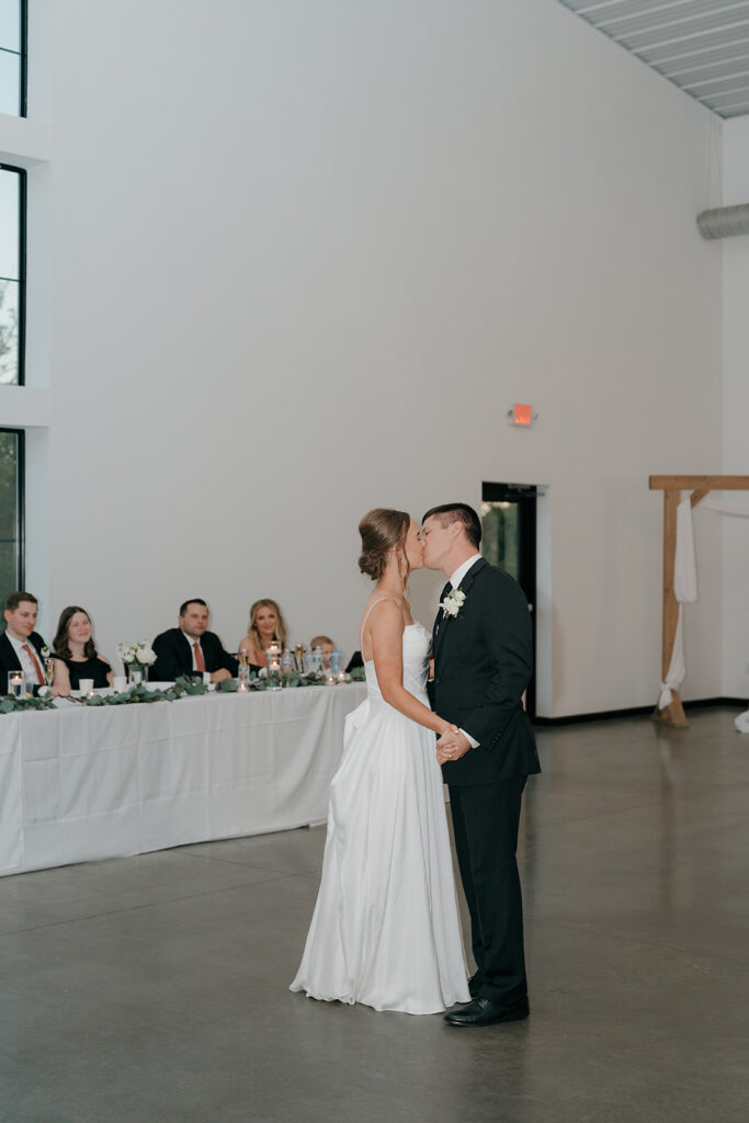 The bride and groom kissing during their first dance.