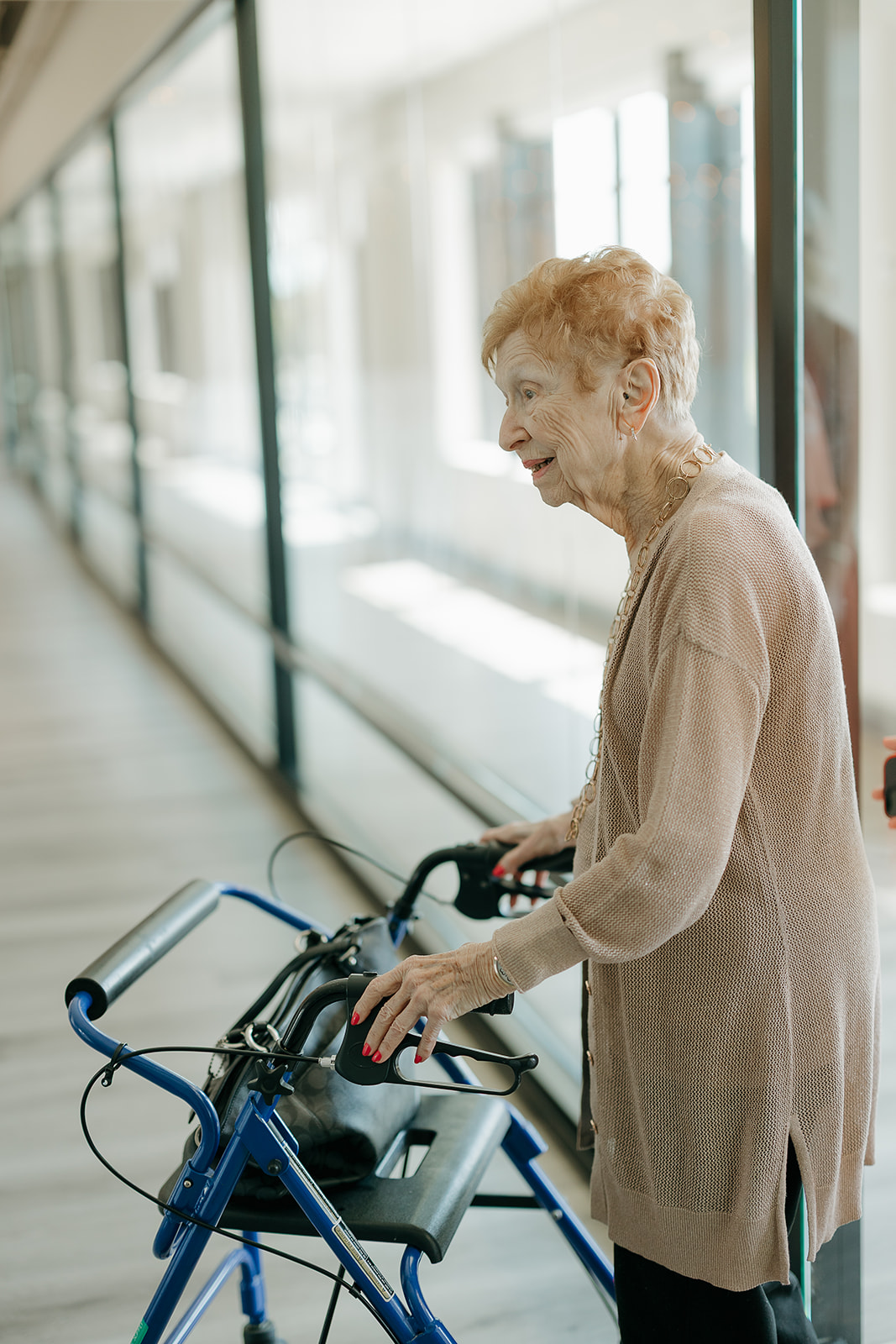 The brides grandma walking into the venue with a walker. Captured by a Des Moines Wedding Photographer