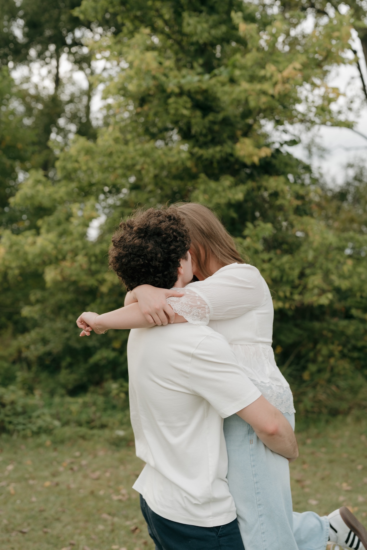 Couple laughing while embracing, captured naturally at one of their favorite Engagement Photo Locations.