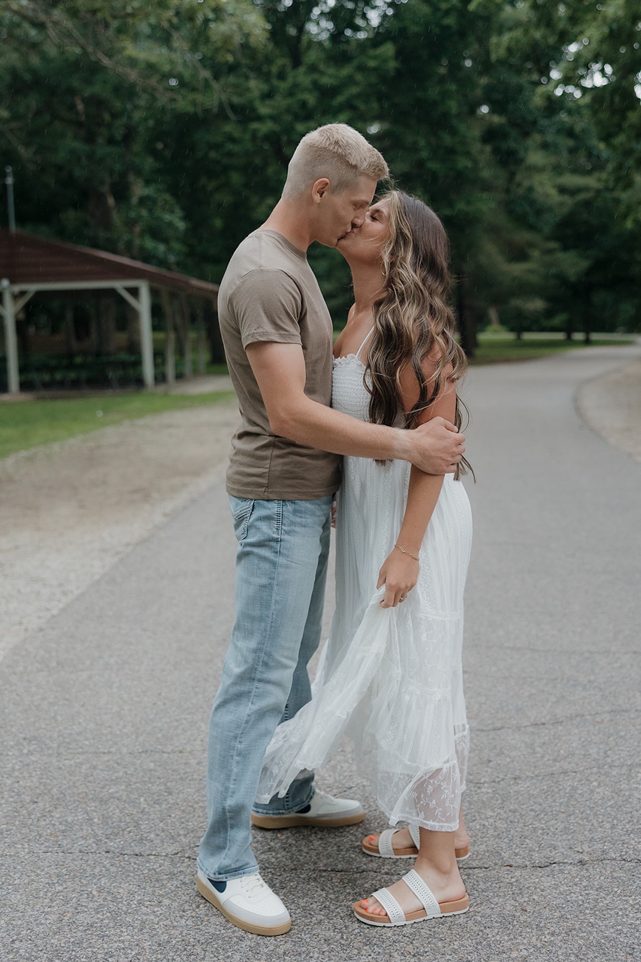 A close-up of an engaged couple sharing a tender kiss outdoors — the kind of shot that makes you want to take engagement photos right now