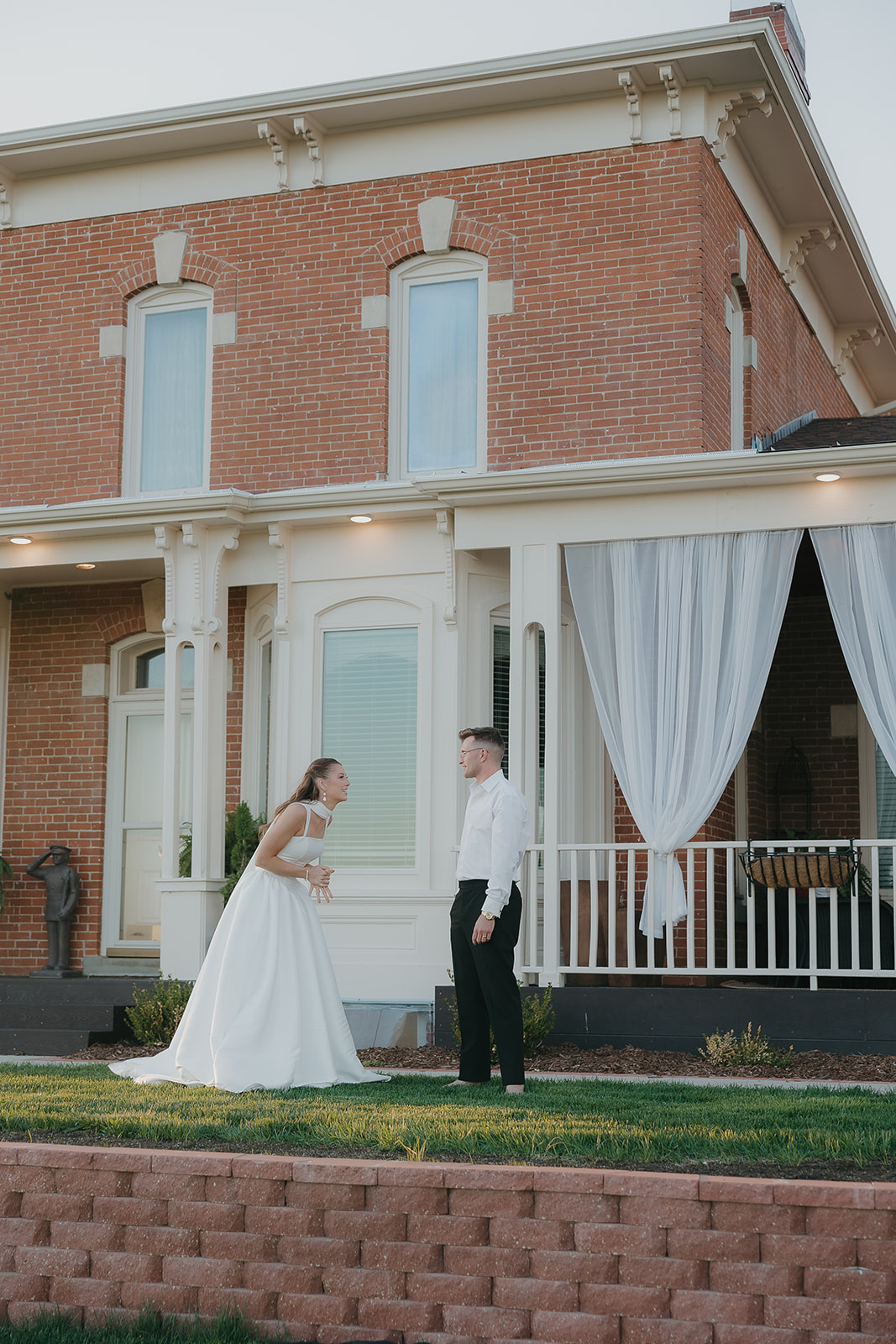 Bride and groom sharing a first look outside a historic brick manor, old money wedding venue
